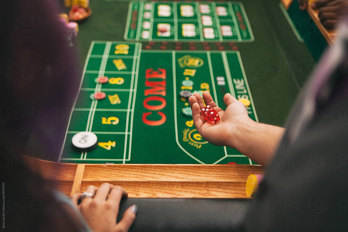 Casino: Man Ready To Roll Dice Onto Craps Table