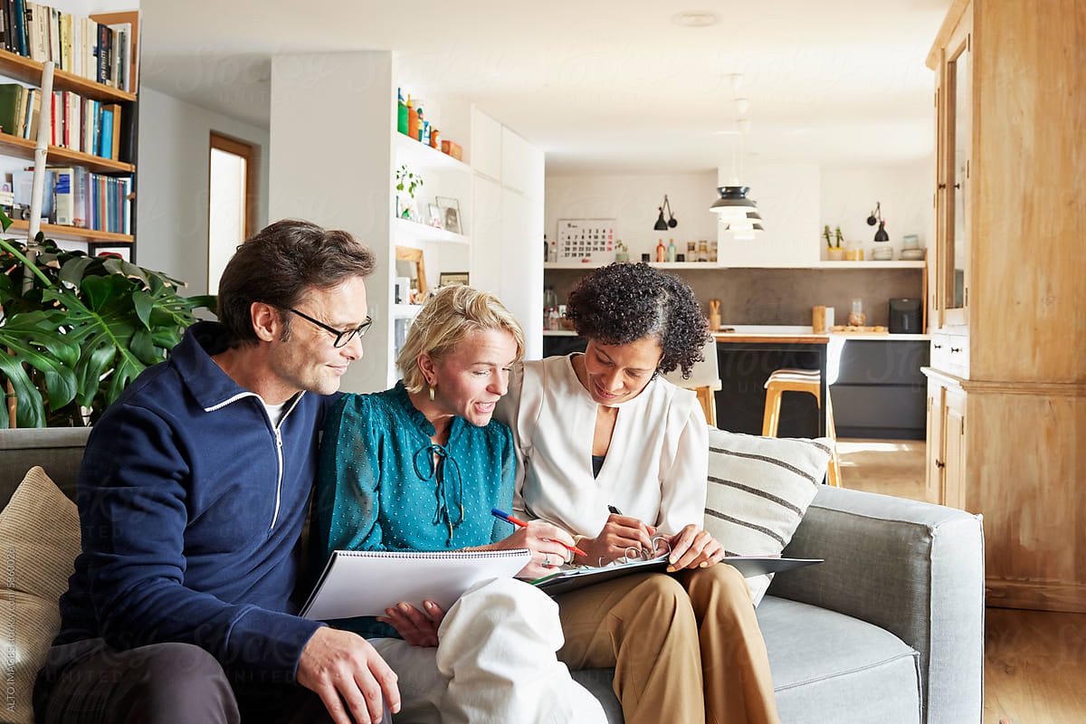 Couple and financial advisor doing paperwork at home