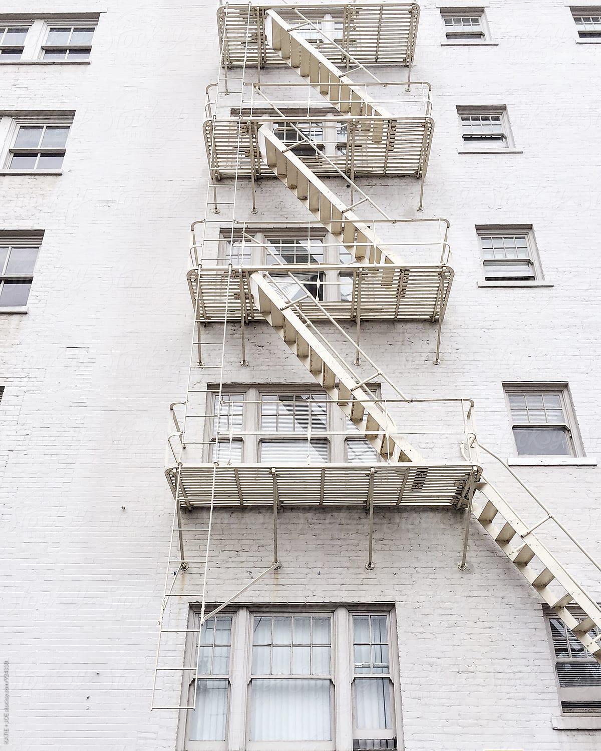 White brick apartment fire escape stairs