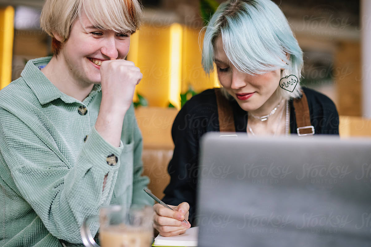 Woman distracting girlfriend from working process