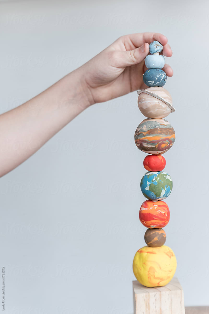 space planet stacking toy with hand 2