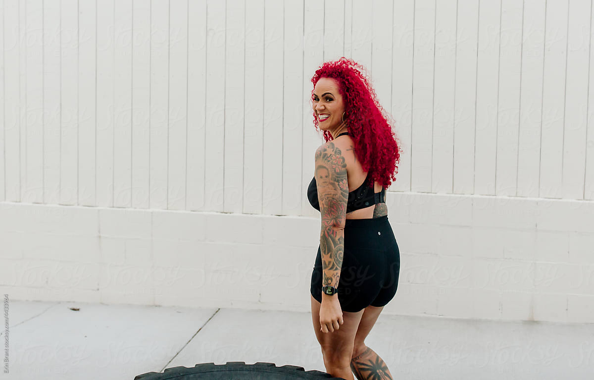 Physically fit woman with red hair