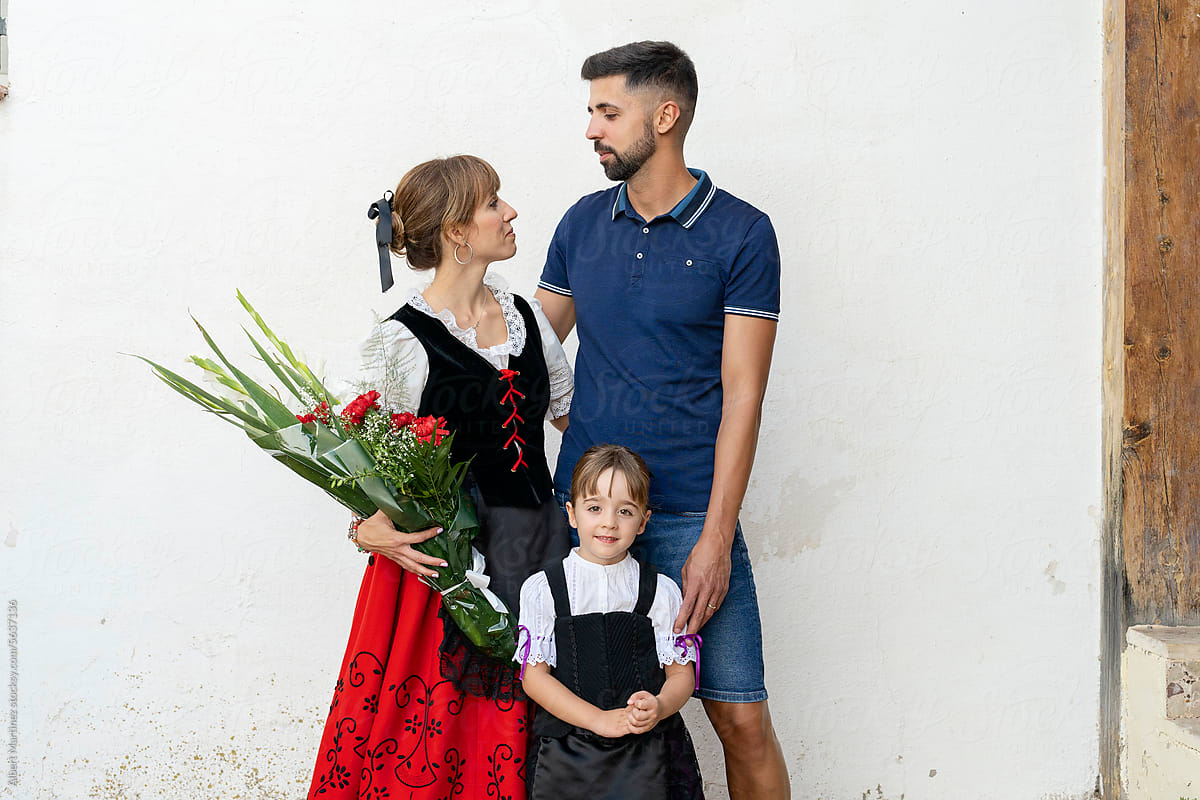 portrait of loving couple with their daughter in traditional dress