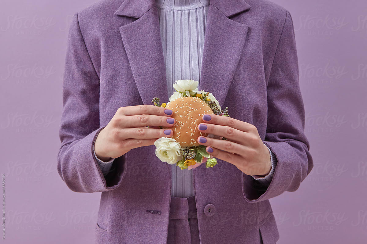 Woman standing with burger with peonies
