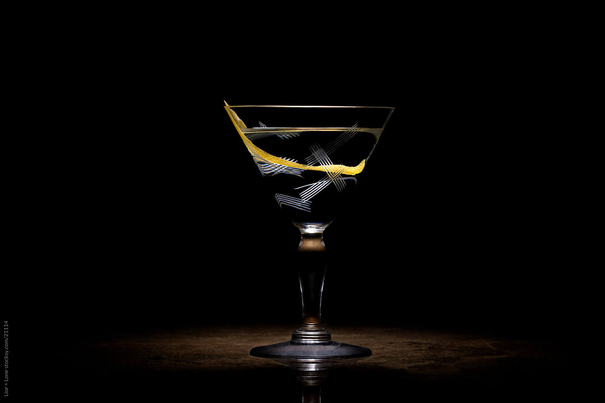 Transparent cocktail with lemon peel