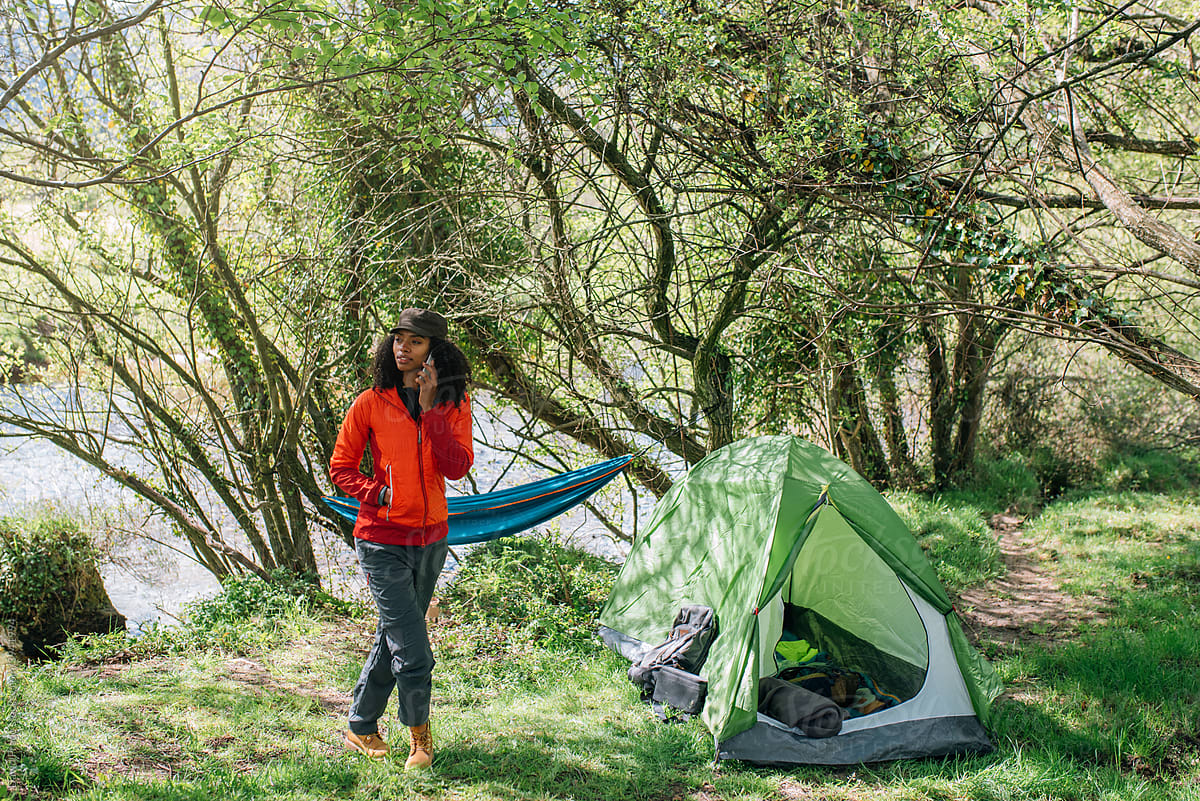 black woman in campsite with tent