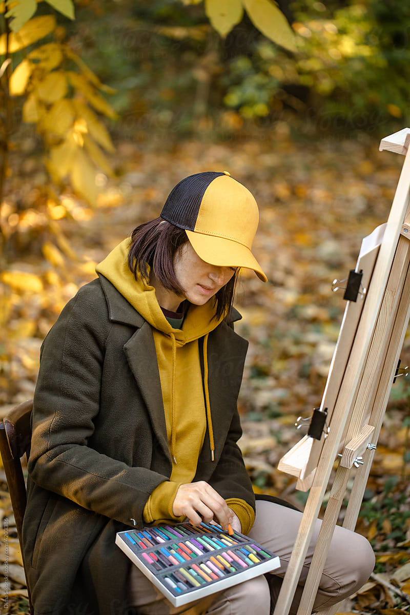 the painter paints in the autumn forest