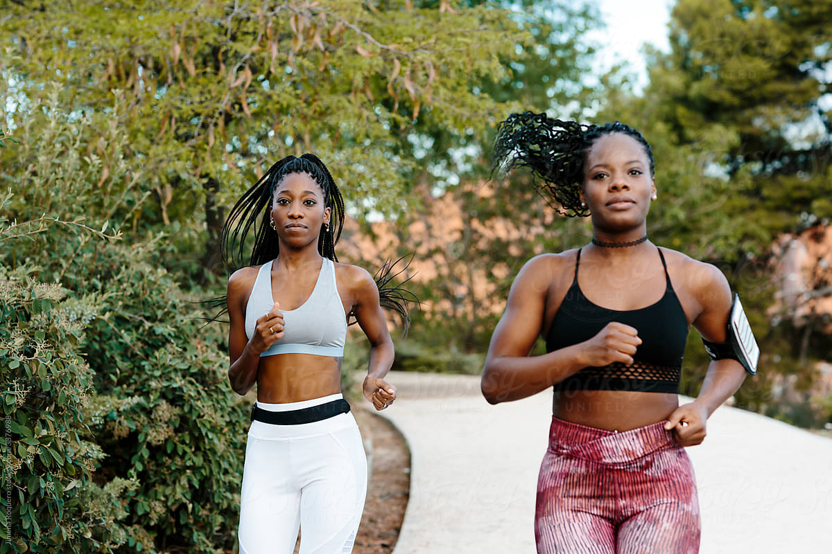 Two women friends jogging outdoors
