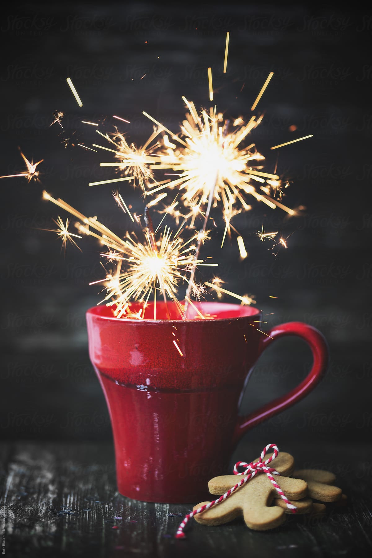 Red mug with sparklers and gingerbread men