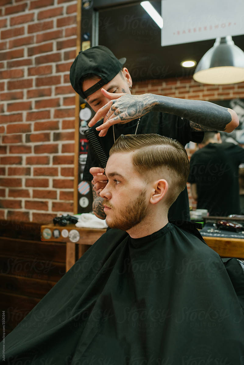 Ginger-haired guy in the chair of a barbershop