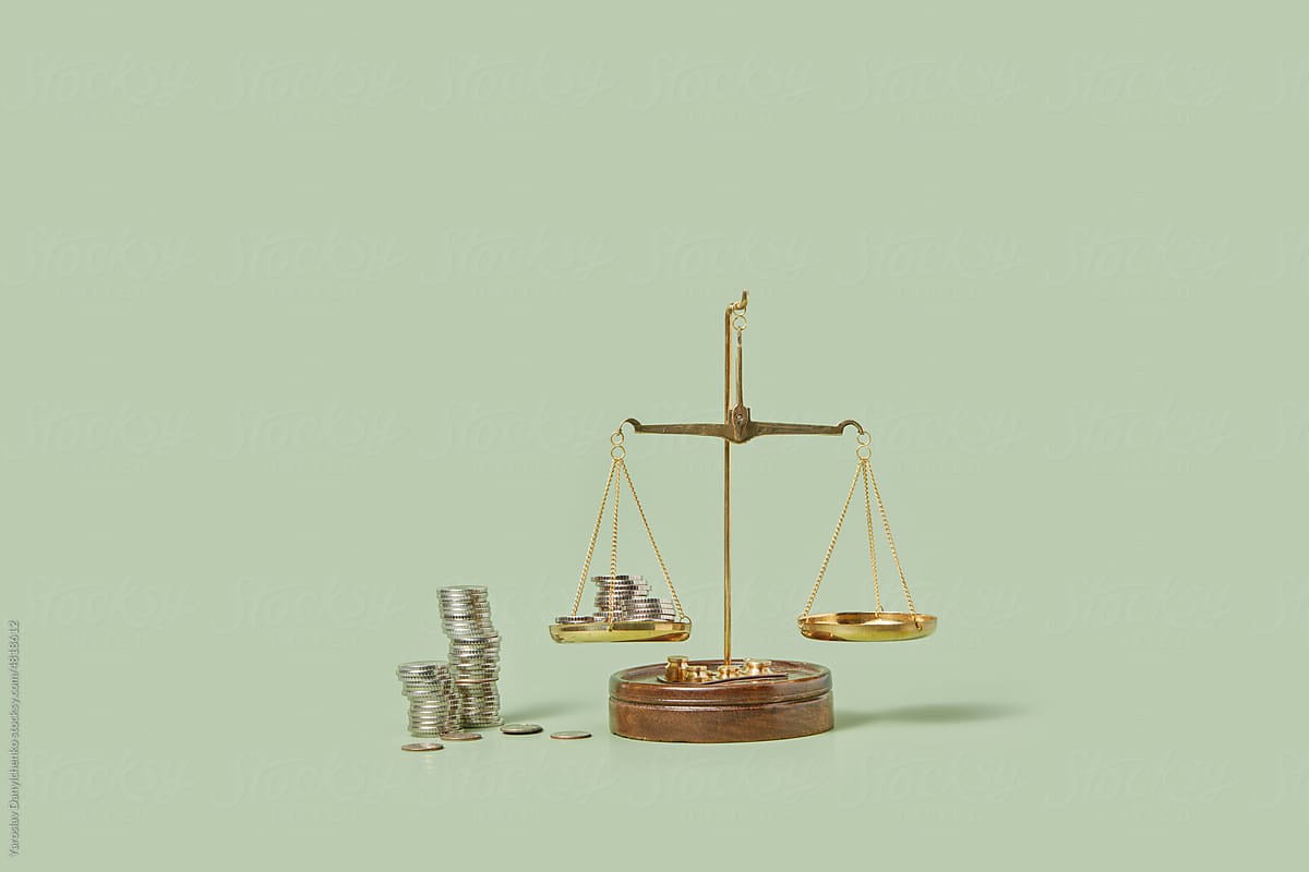 Silver coins weighed on balanced scales.