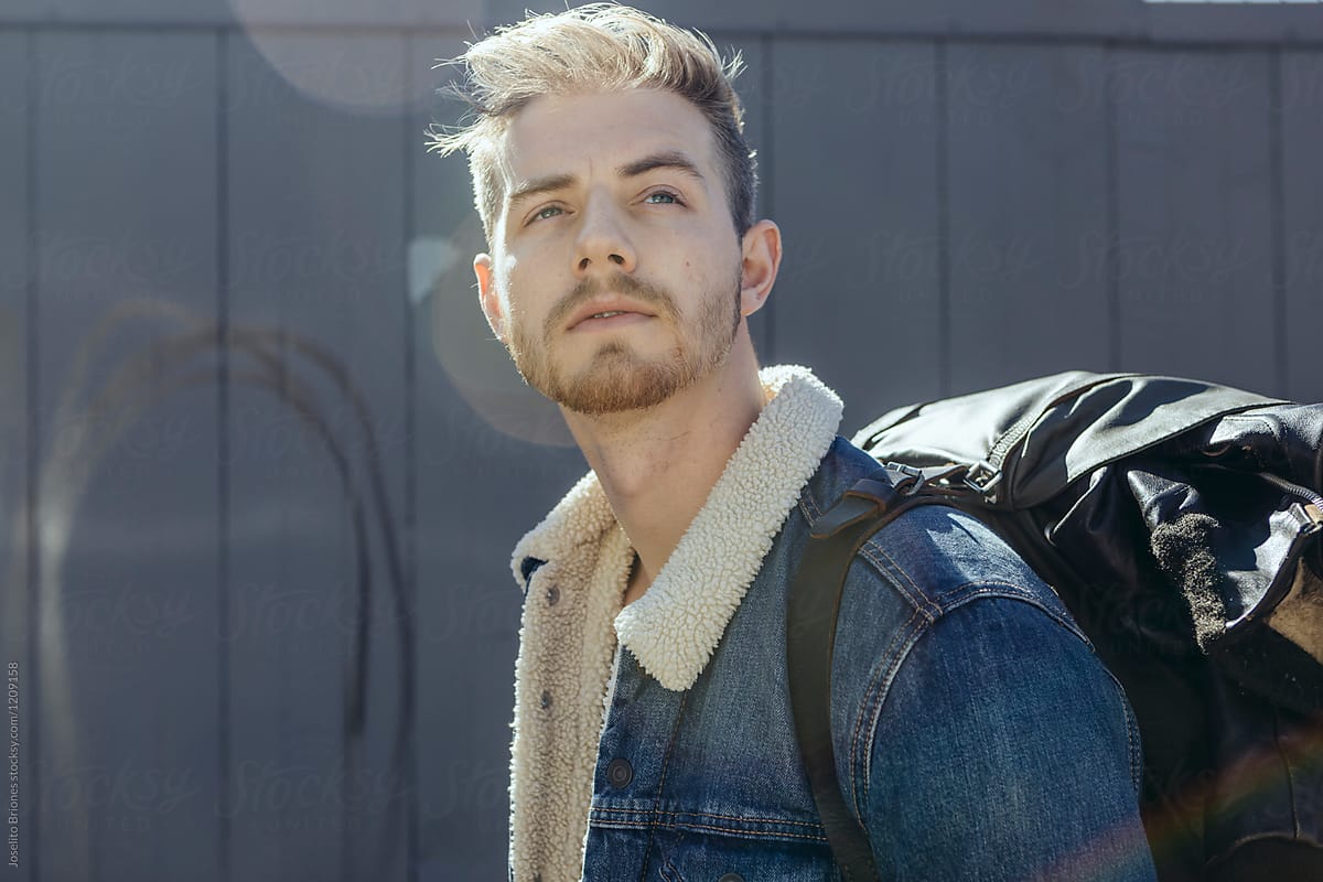 Portrait of Man in  Shearling Lined Denim Jacket Carrying Leather Backpack