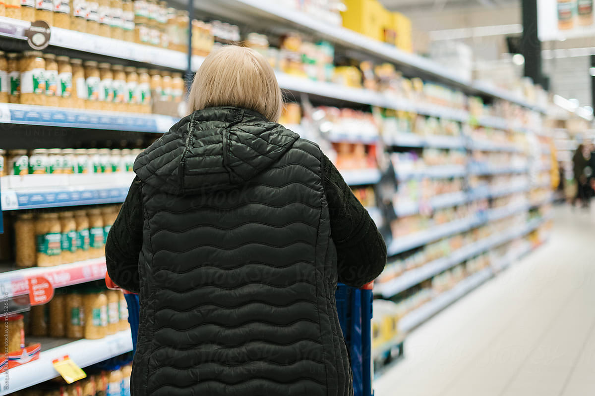 Woman choosing products in supermarket