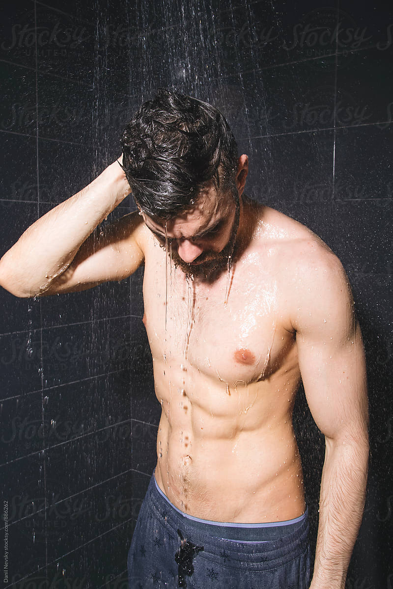 Man wearing pants having shower
