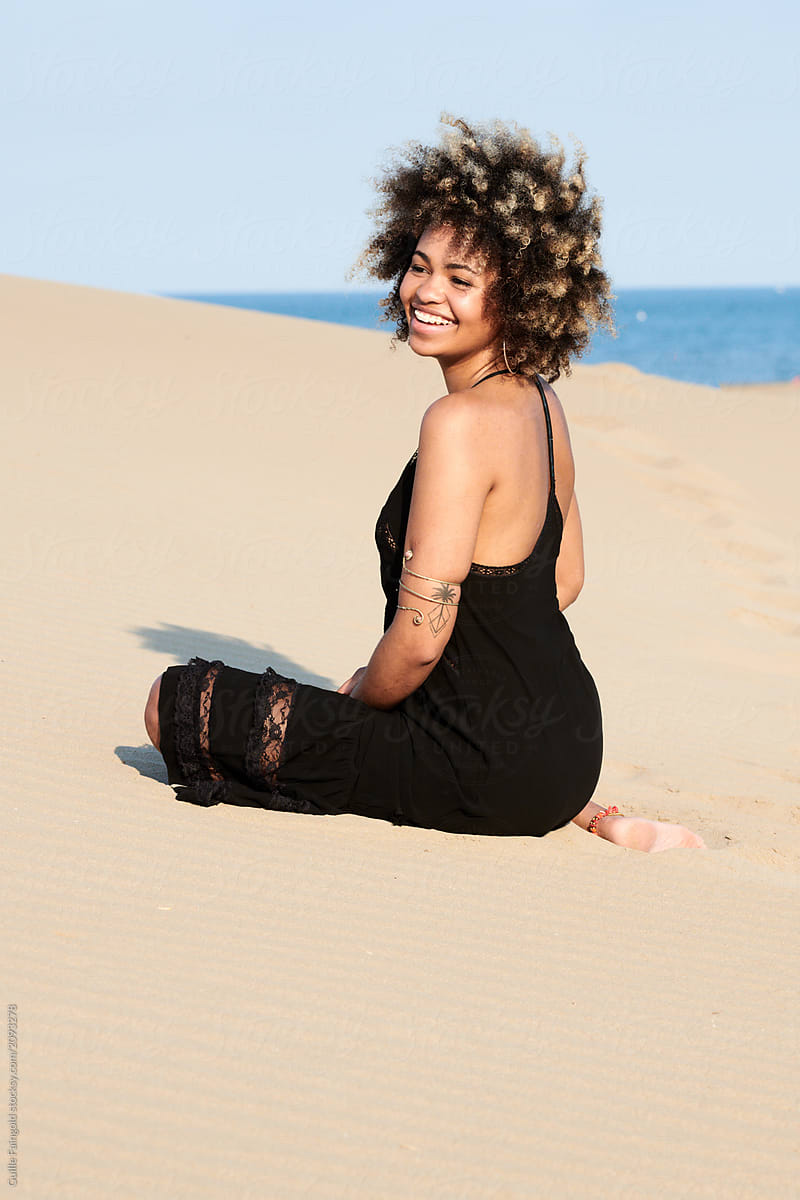 Smiling Woman Sitting On Dune At Sea By Stocksy Contributor Guille Faingold Stocksy 