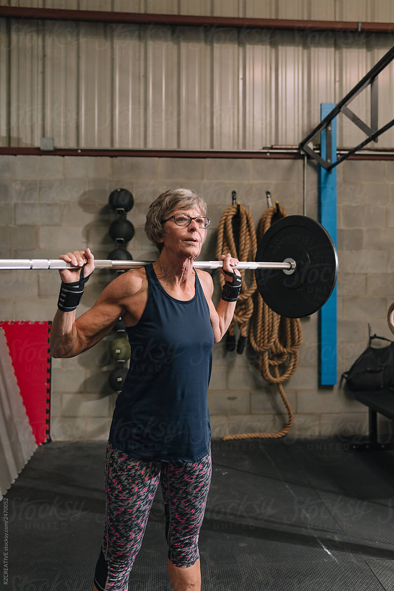 Senior woman lifting at gym