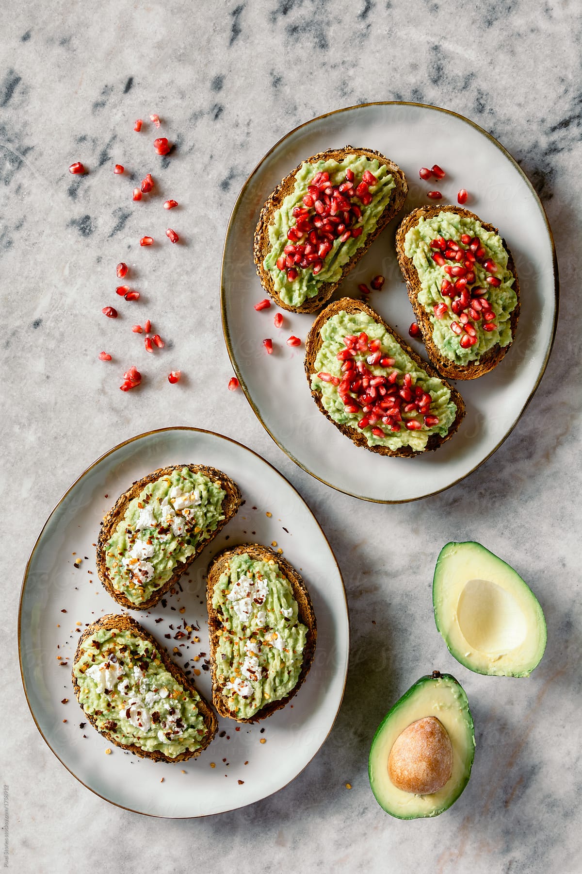Avocado sandwiches with pomegranate seeds and white cheese