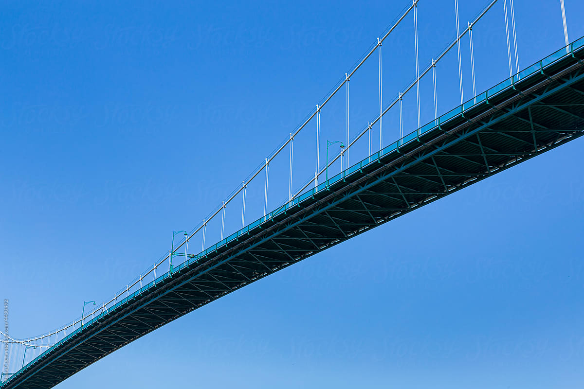 A suspension bridge with the sky in the background