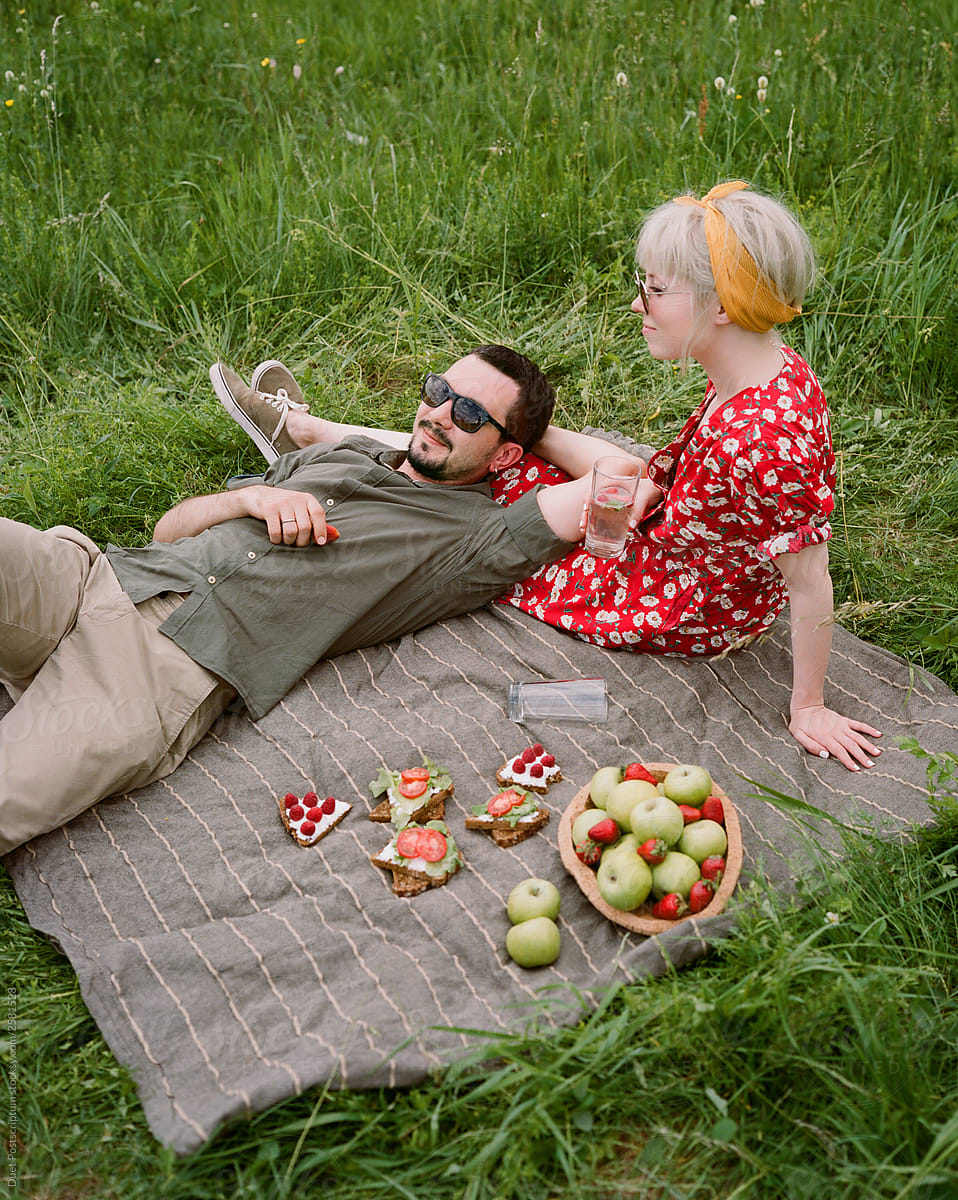 Happy young couple having romantic time and enjoying a summer picnic