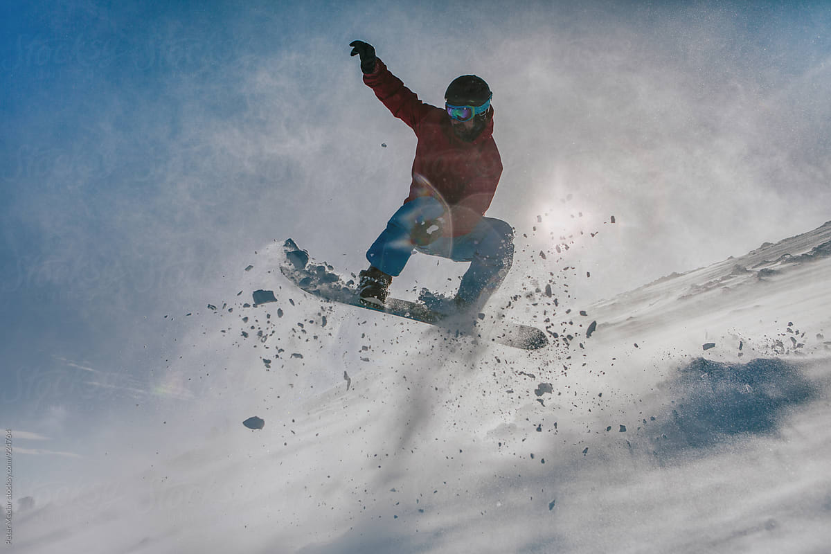 snowboarder jumping down the hill