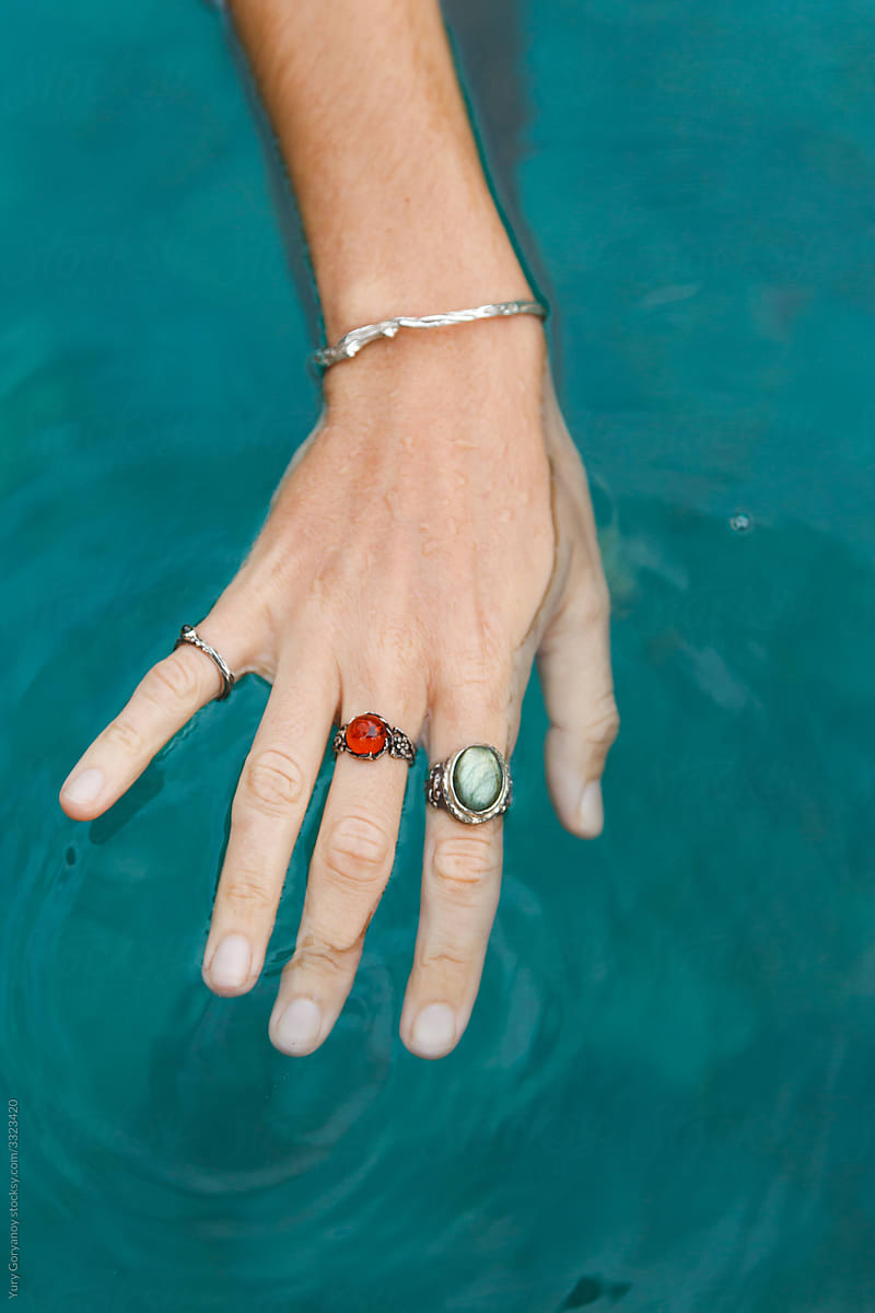 Hand with rings on the water