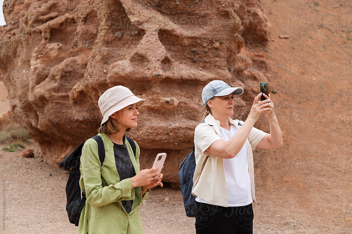 Travelers taking photos of canyon during tour