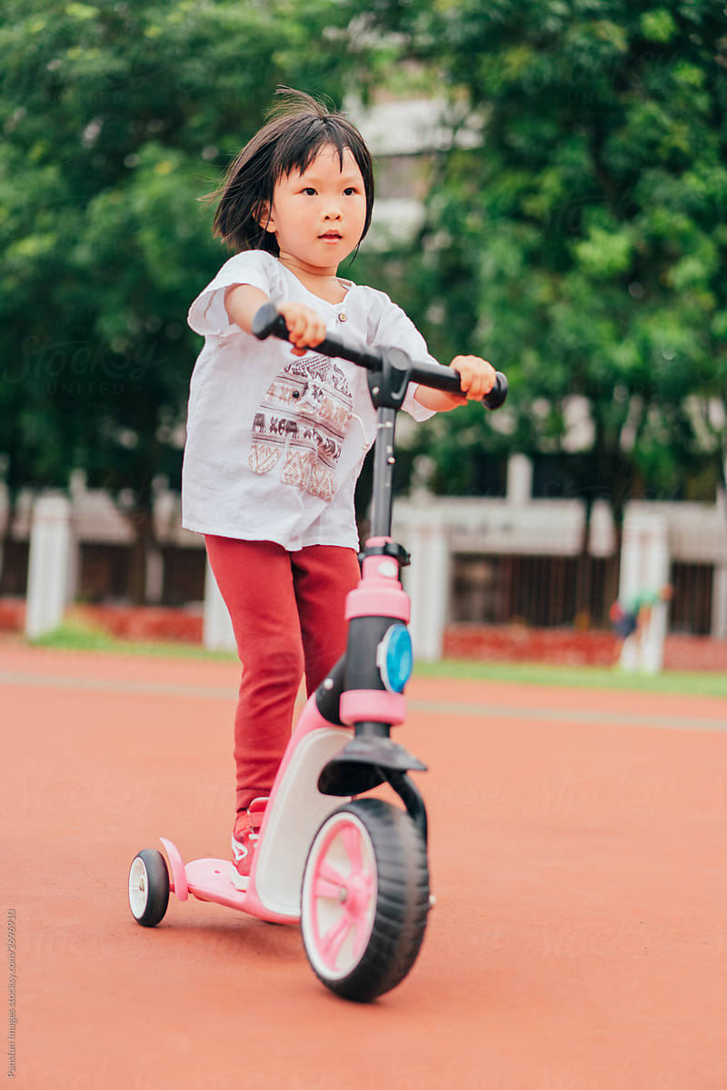 Little girl playing scooter