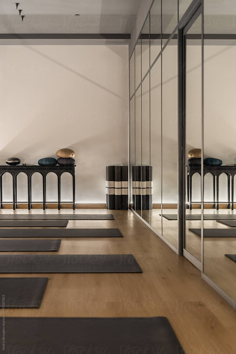 Modern Interior Of Yoga Studio With Mirrored Wall by Stocksy Contributor  Andriy Bezuglov - Stocksy