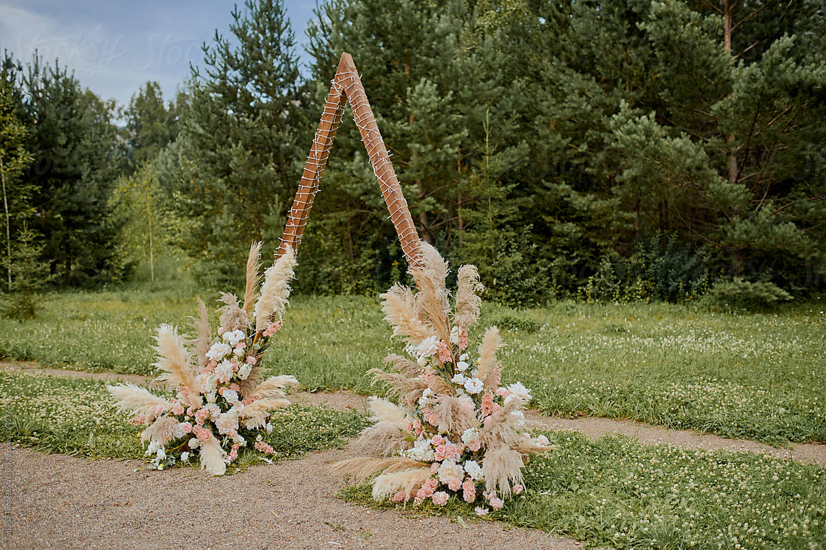wedding ceremony arch and chairs in rustic boho style