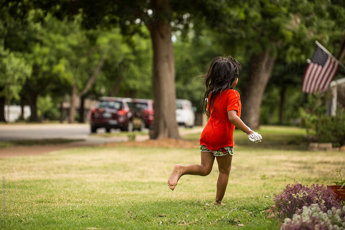 Girl running through yard