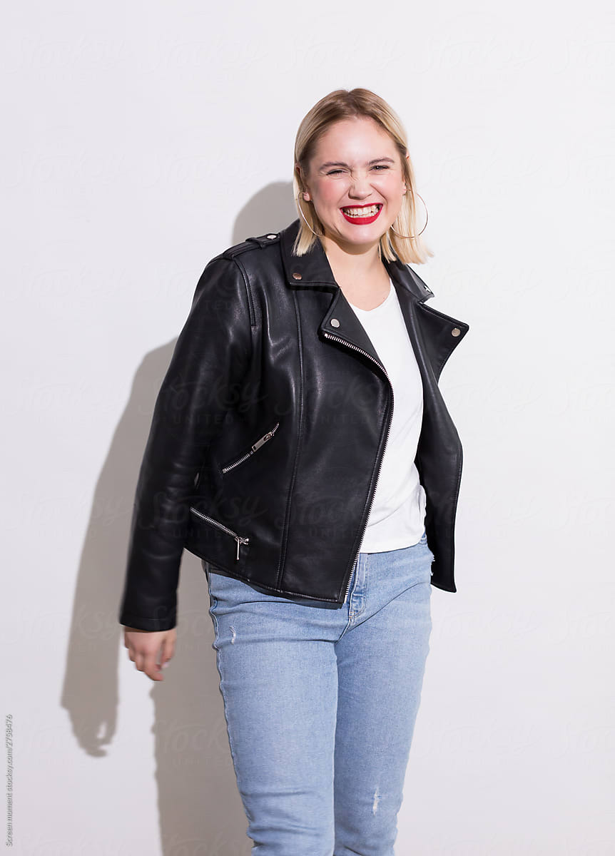 Beautiful Blonde Plus Woman Jeans And Leather Jacket Laughs On A White Background Screen Moment