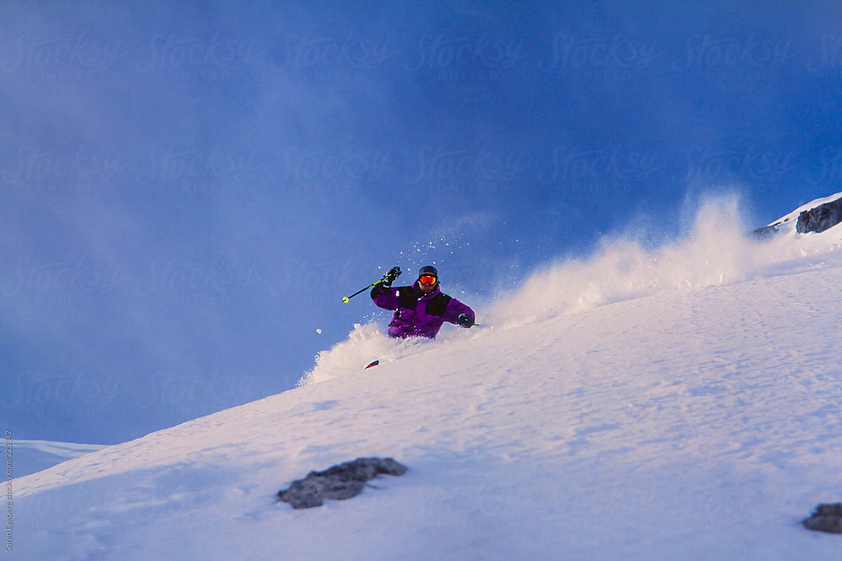 Man snow skiing in winter mountain landscape