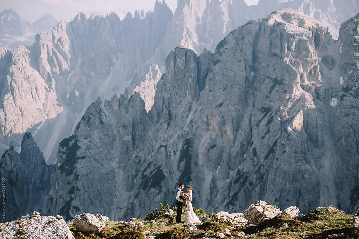Newlyweds at wedding ceremony on mountain background