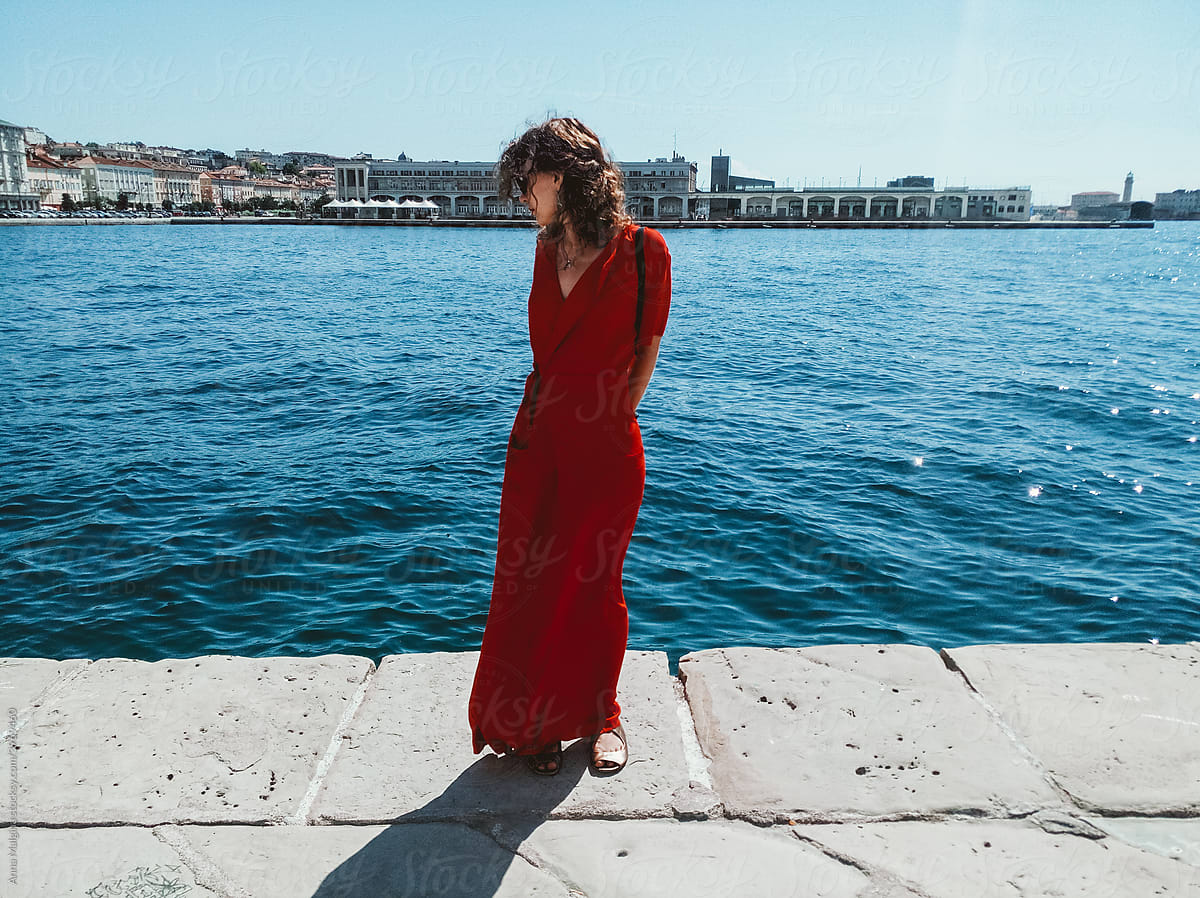 A woman in red in a italian sea port