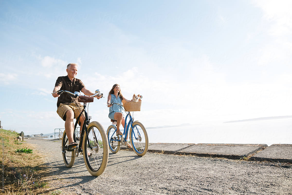 Healthy, active couple enjoying life riding cruiser bikes near o