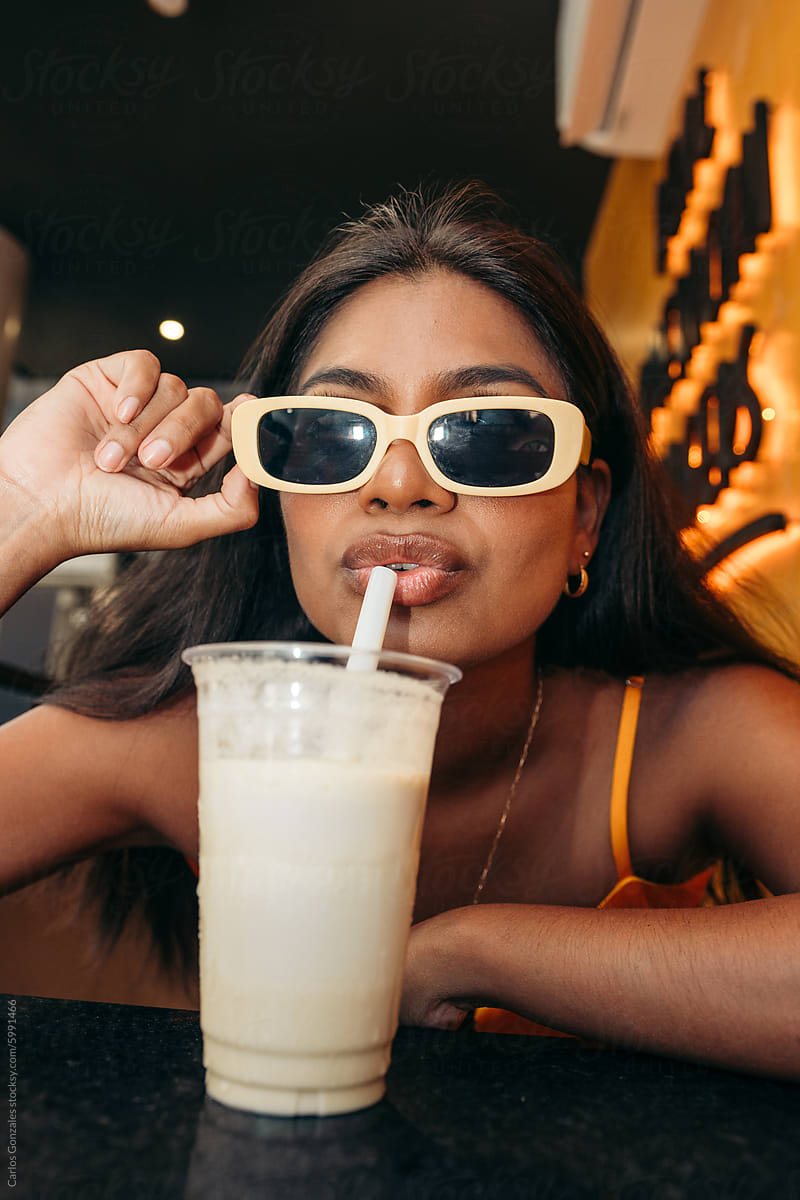 Woman drinking vanilla milkshake