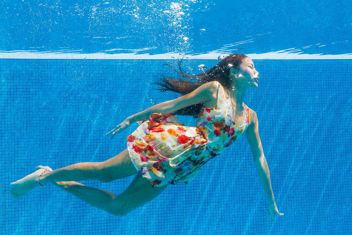 Underwater in summer dress floating