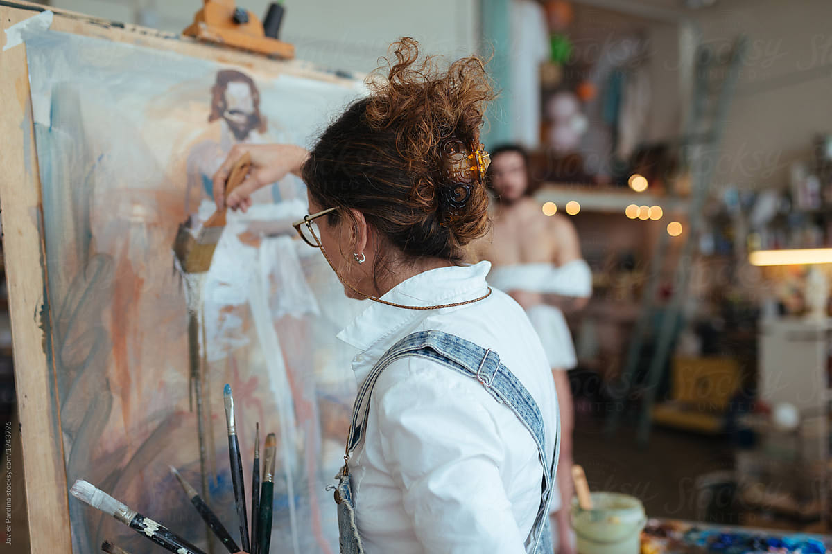 Woman drawing model with artistic technique on canvas