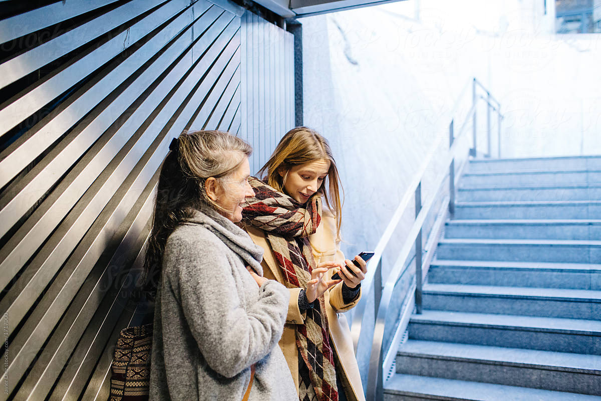 Women using smartphone in subway