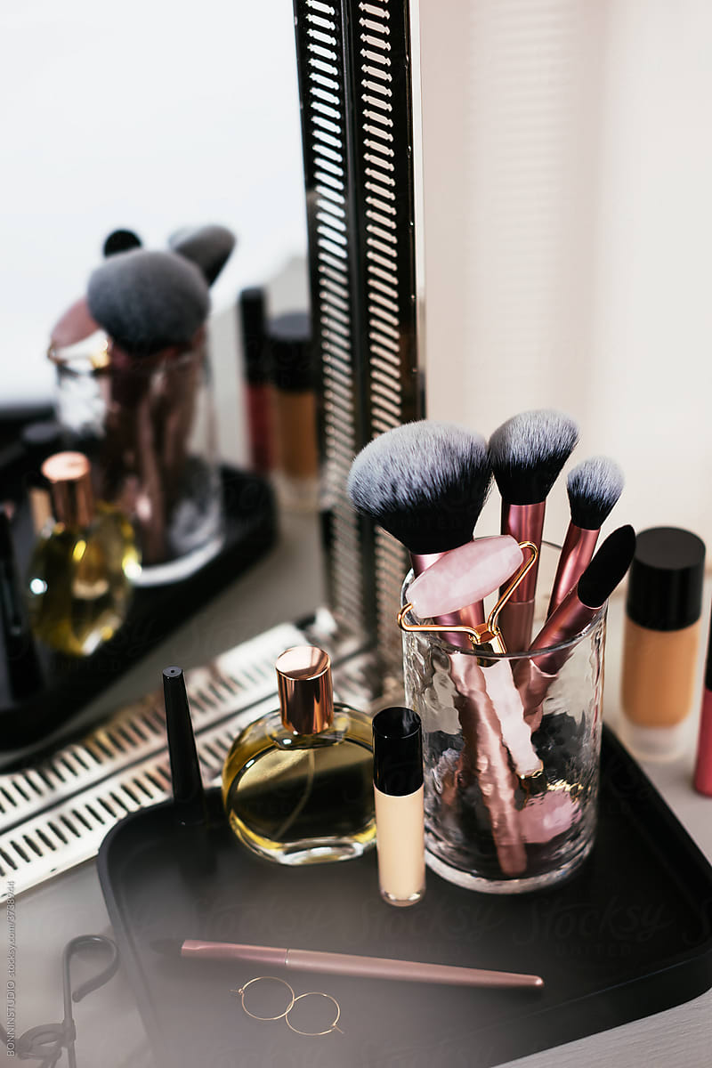 Makeup products and perfume near mirror