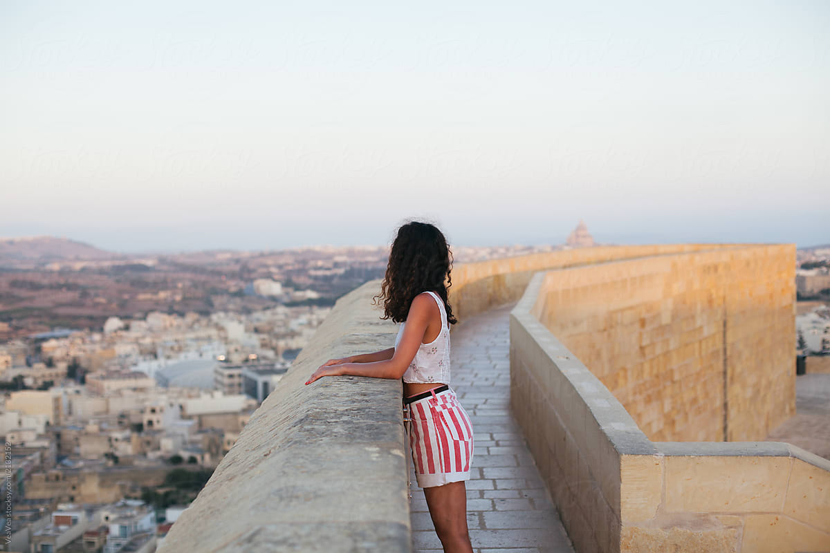 Unrecognizable woman looking at the city line of Victoria. Gozo