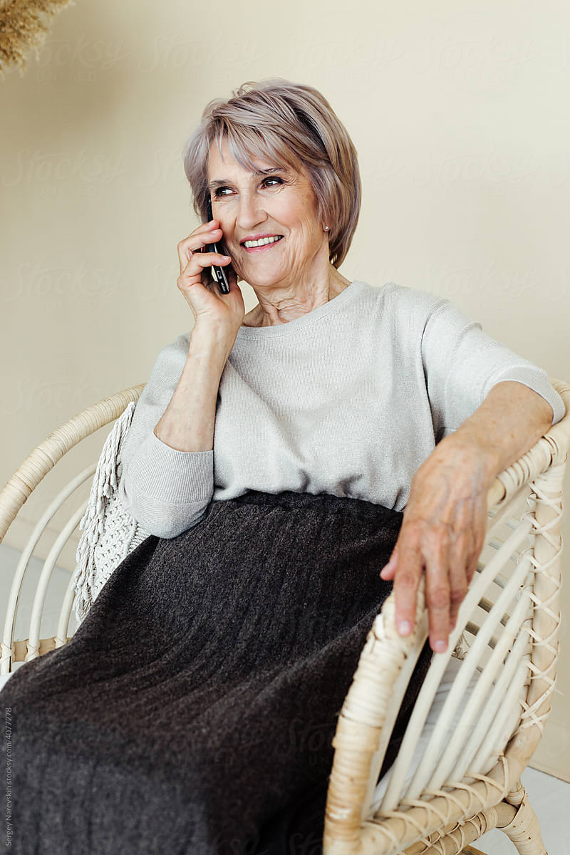 Smiling senior woman speaking on phone