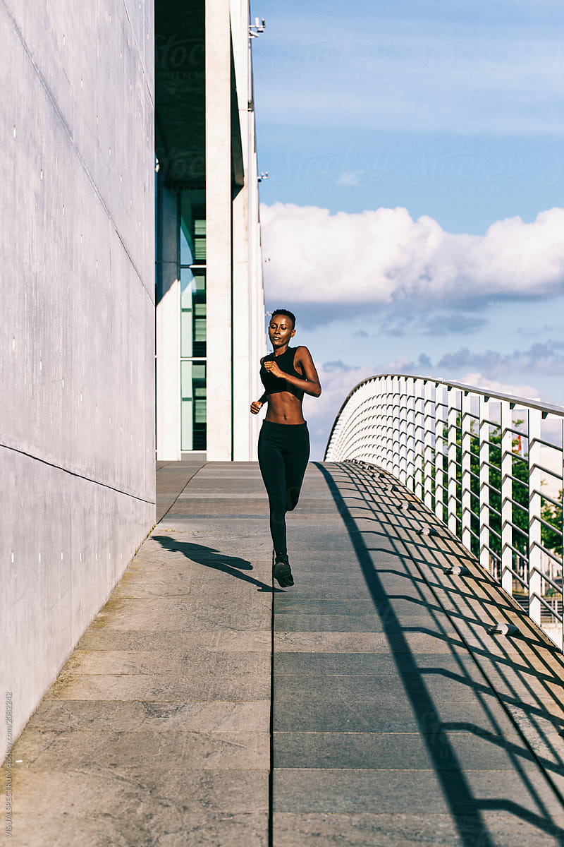 Young Fit African Woman Jogging in Urban Environment