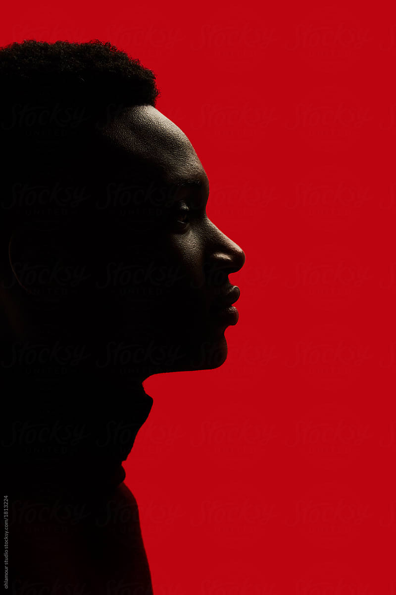 African American man portrait profile silhouette isolated over red - closeup eyes open