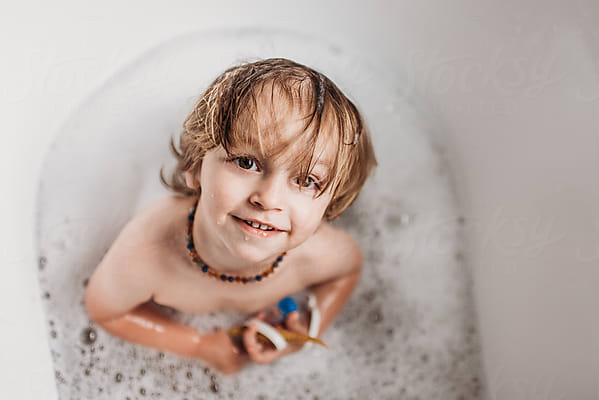 Toddler Enjoying A Bubble Bath At Home by Stocksy Contributor