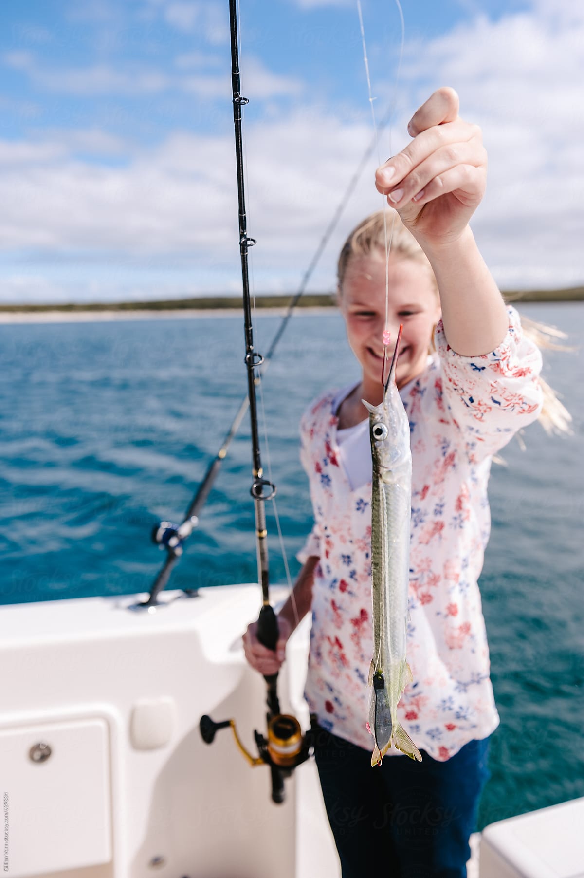 Teenager Catching A Fish by Stocksy Contributor Gillian Vann - Stocksy