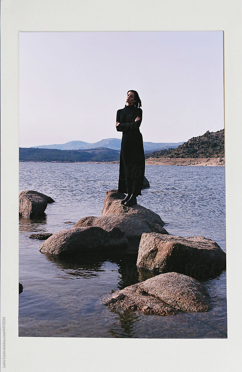 Analogical photo of a woman standing alone on the rock