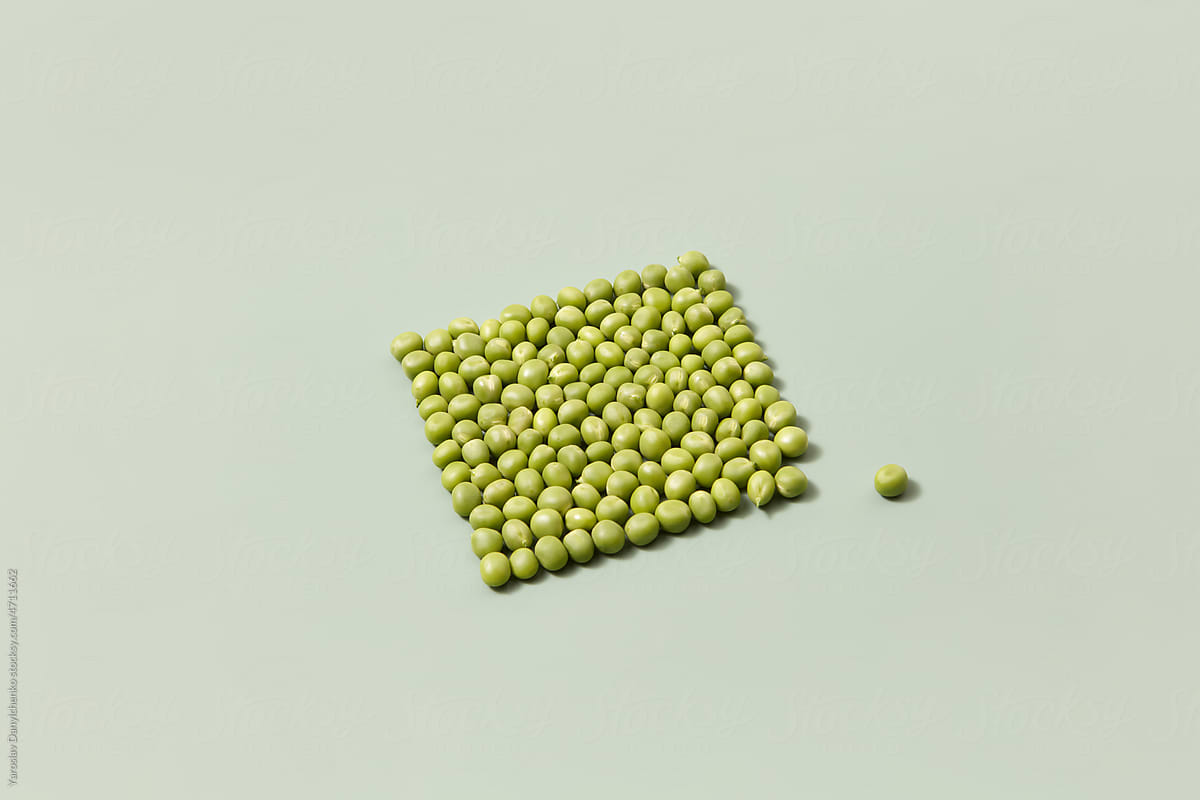 Green peas in form of square, one bean is apart.