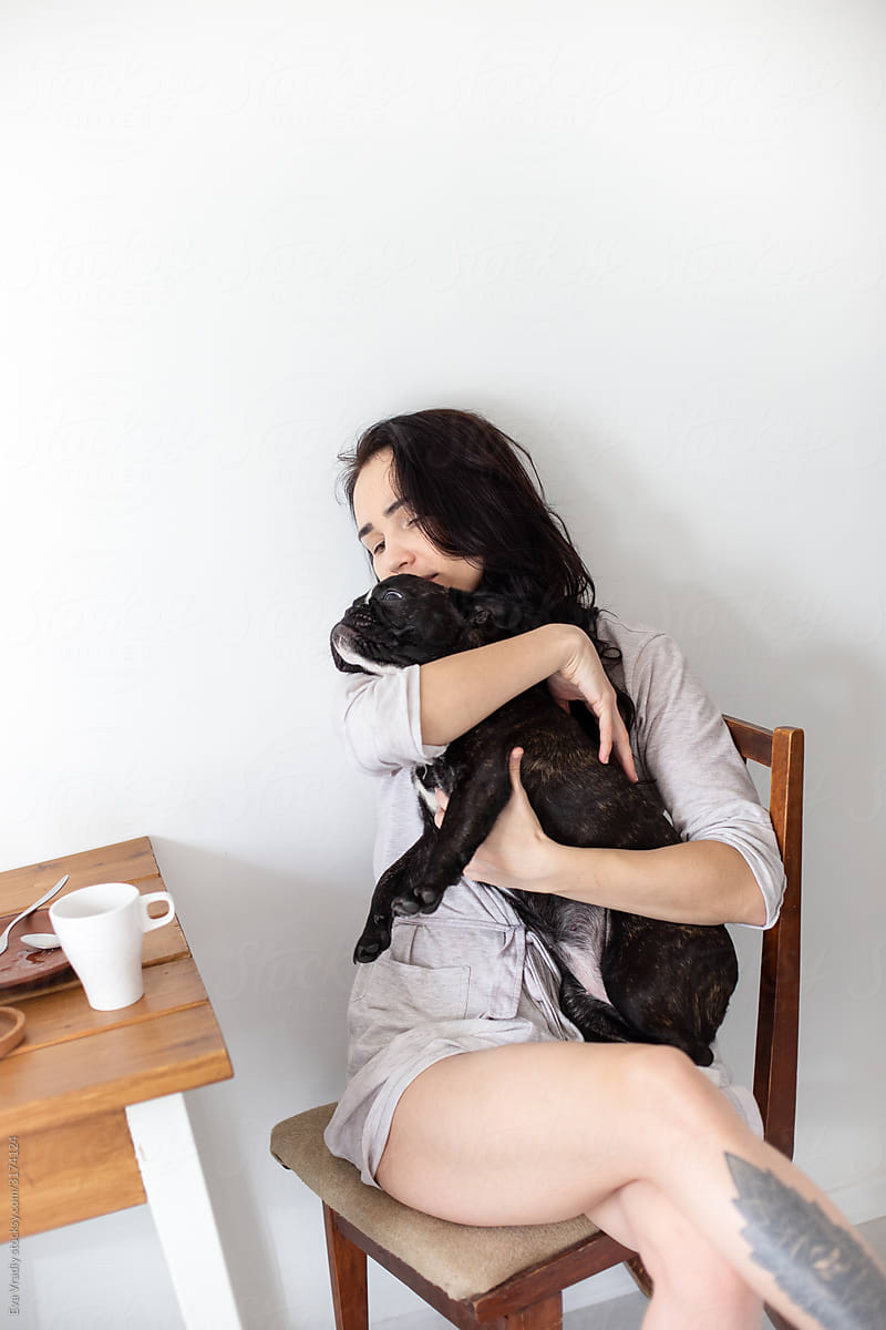 Young woman hugging cute dog