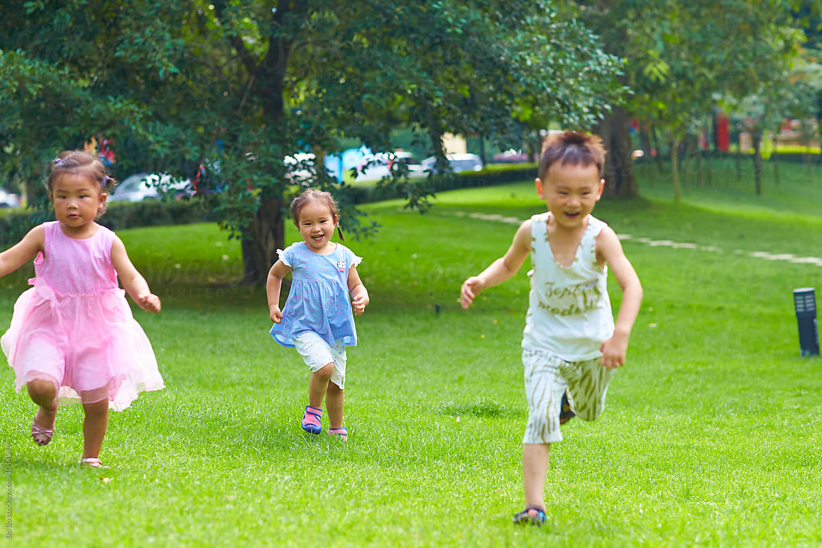 Happy Kids Playing Outdoor In The Park By Bo Bo